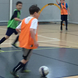 Image of Boys in Gym traing with futsal ball - premiere indoor training - World Class Soccer School